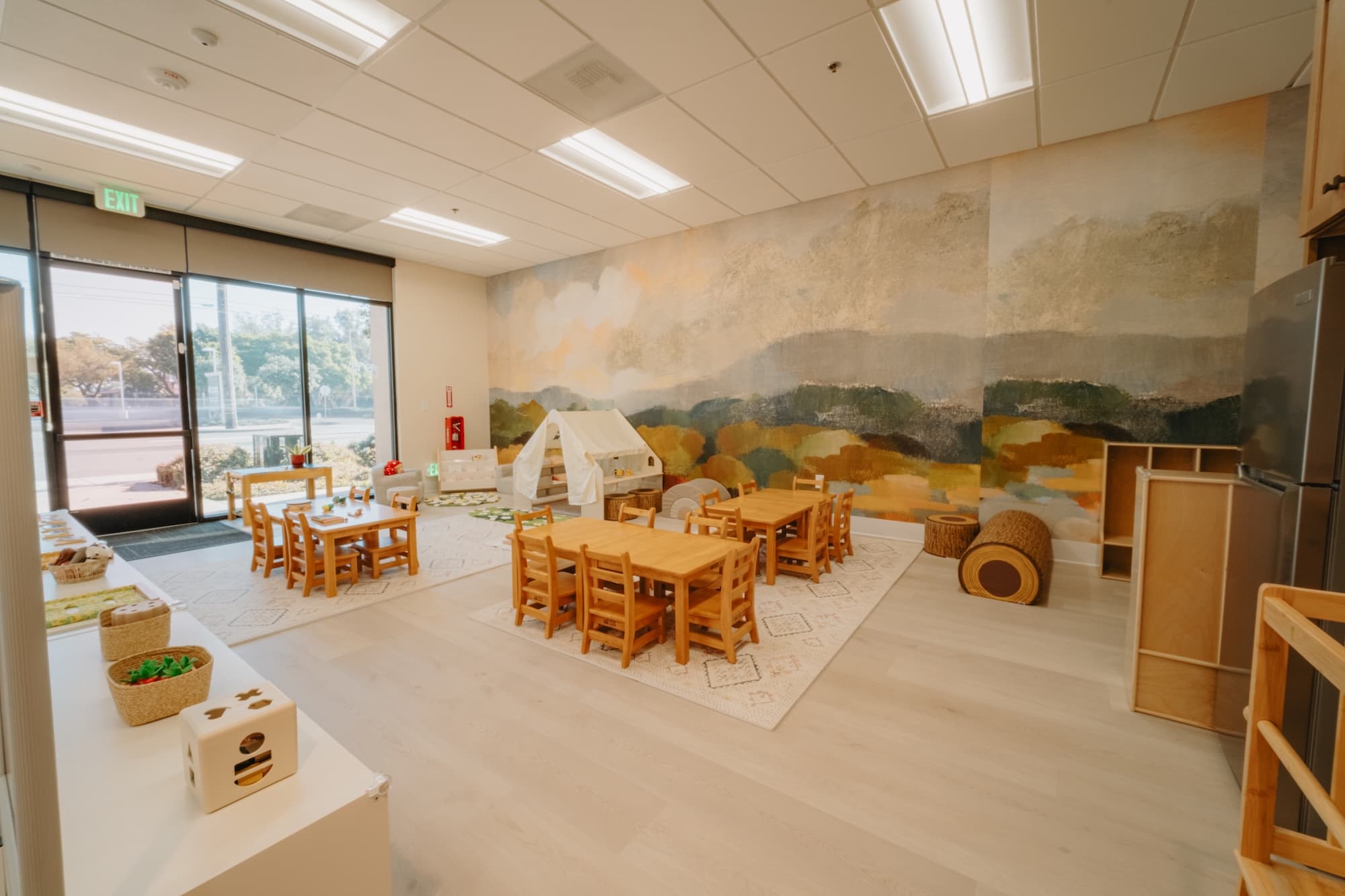Preschool classroom with woodland mural at Ohana Montessori